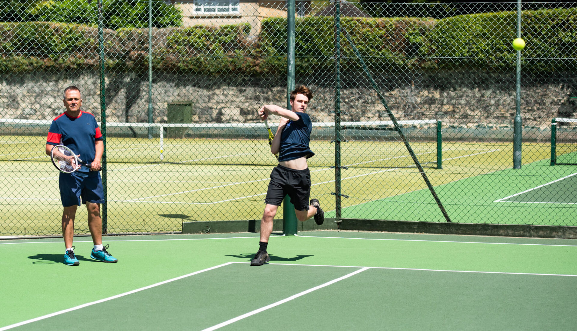 Tennis Lessons - Performance tennis lesson with Rich Little with player hitting inside out forehand